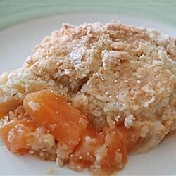 a close up of a plate of food with some fruit on it and crumbs