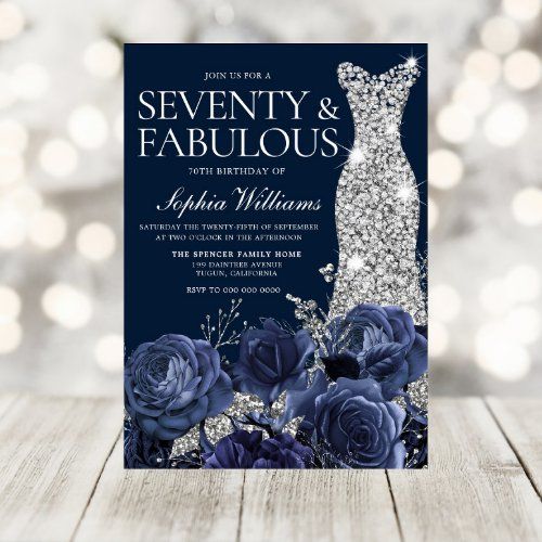 an elegant wedding card with blue roses and diamonds on it, in front of boke lights