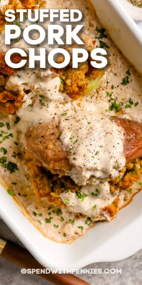 stuffed pork chops with gravy in a white casserole dish