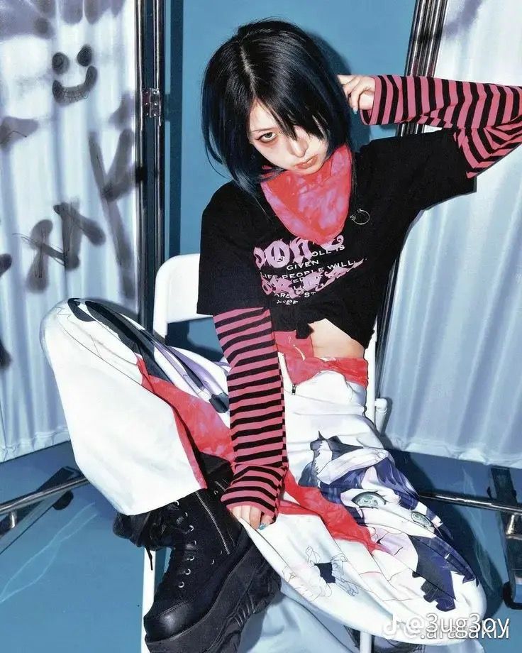 a woman sitting on top of a white chair wearing black and red striped socks with her hands behind her head