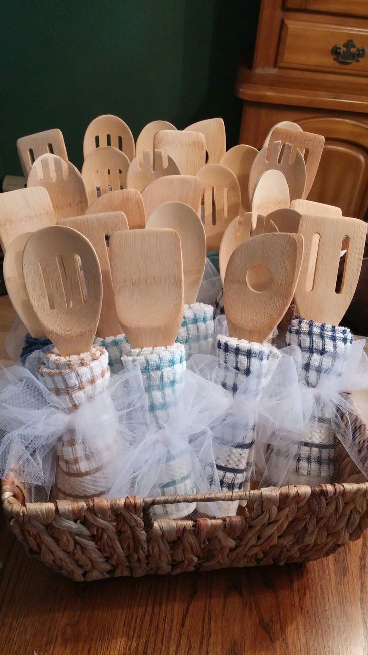 several wooden spoons in a basket on a table