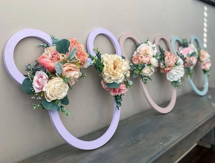 flowers are arranged in the shape of an o sign on a wall next to a fireplace