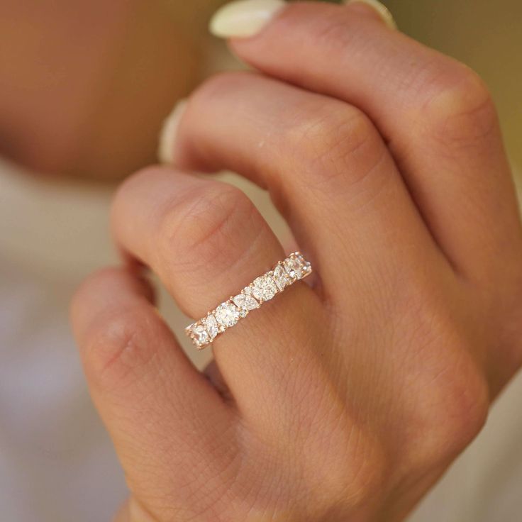 a woman's hand with a diamond ring on it