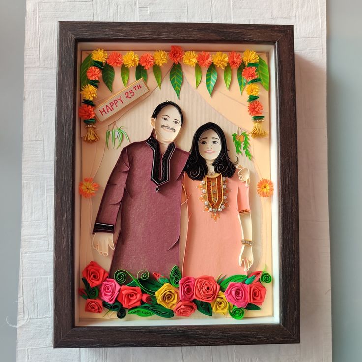 an image of a couple in front of flowers on a white wall with a wooden frame