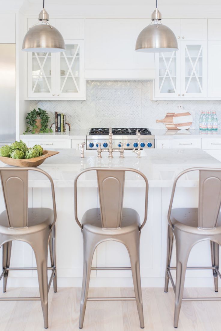 three chairs are sitting at the kitchen island