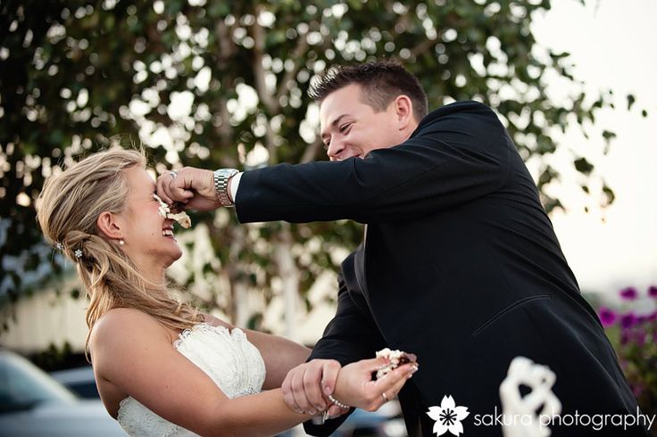 a bride and groom feeding each other cake