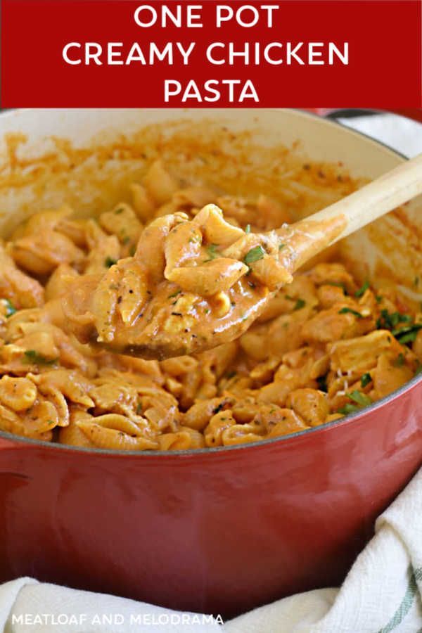 one pot creamy chicken pasta in a red skillet with a wooden spoon and text overlay