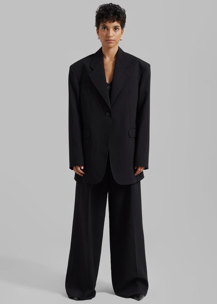 Color: Black Midweight suiting fabric Oversized fit Notch lapels Padded shoulders Front flap pockets Front button closure Lined 81% Polyester 15% Rayon 4% Elastane Dry Clean By The Frankie Shop. Imported Tailored Black Pantsuit With Lapel Collar, Black Tailored Pantsuit With Lapel Collar, Tailored Black Pantsuit, Structured Black Semi-formal Suit, Business Pantsuit With Welt Pockets And Lapel Collar, Business Pantsuit With Lapel Collar, Classic Single Breasted Pantsuit For Work, Black Oversized Blazer For Formal Occasions, Classic Single-breasted Pantsuit For Work