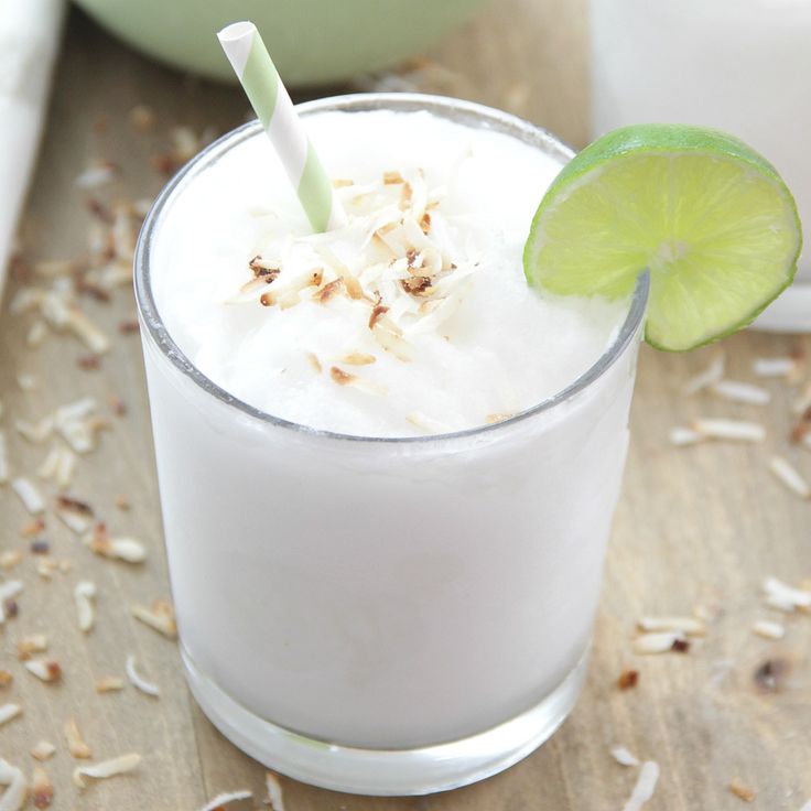 two glasses filled with milk and topped with a lime