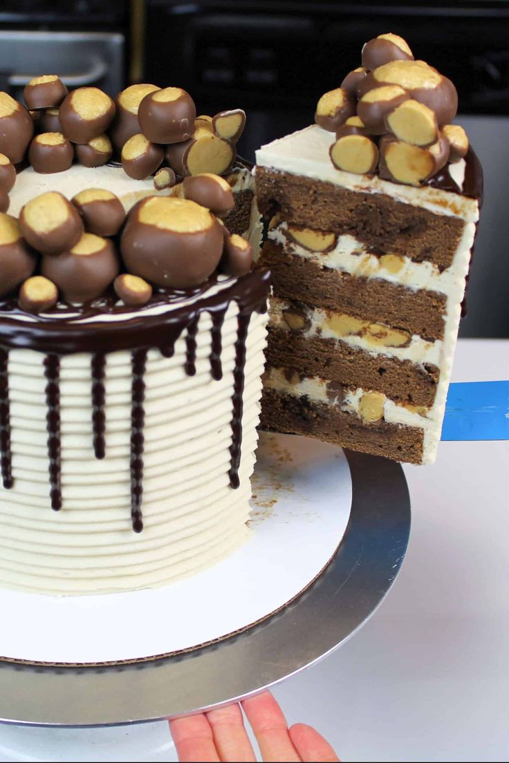 two pieces of cake with chocolate and white frosting on the top are being cut