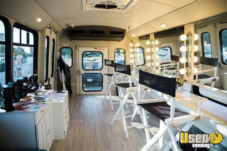 the inside of a bus with lots of chairs and mirrors on it's sides