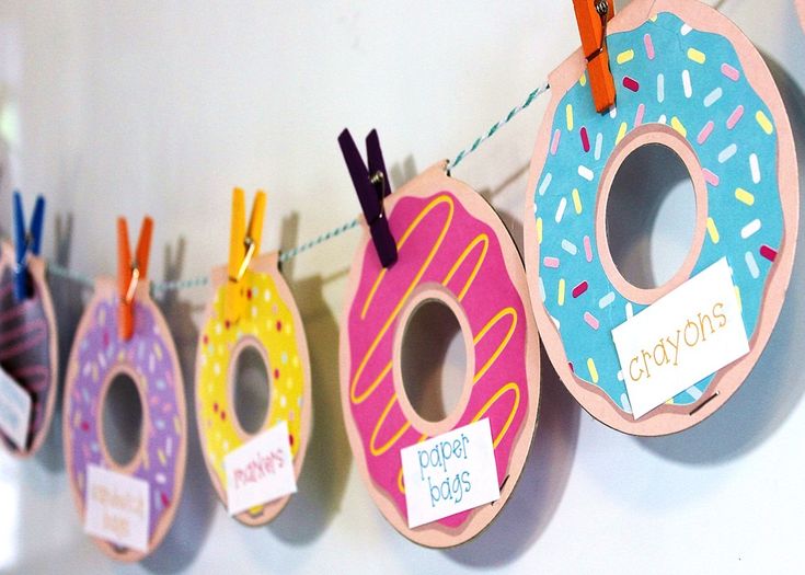 doughnuts are hung on the clothes line with name tags attached to them,