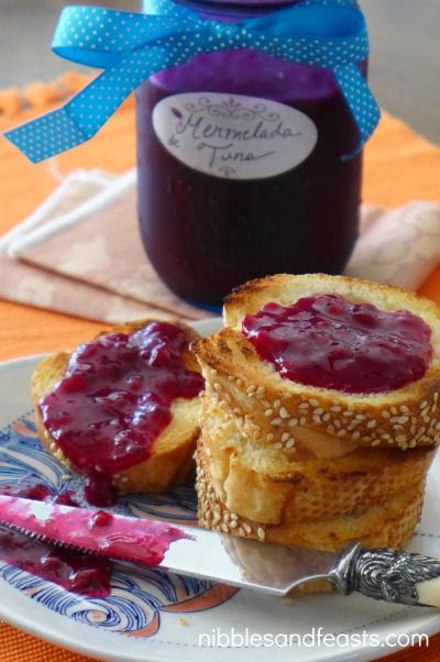 two peanut butter and jelly sandwiches on a plate next to a jar of jelly jam