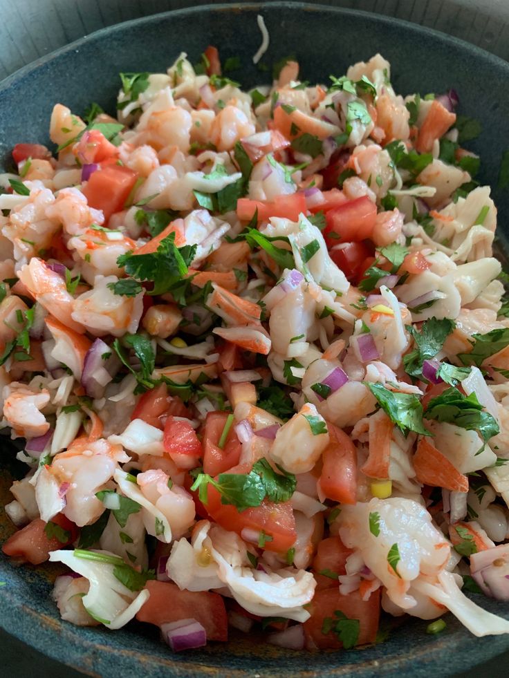 a bowl filled with lots of food on top of a table