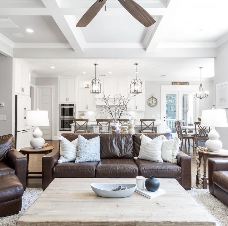 a living room filled with furniture and a ceiling fan in the middle of the room