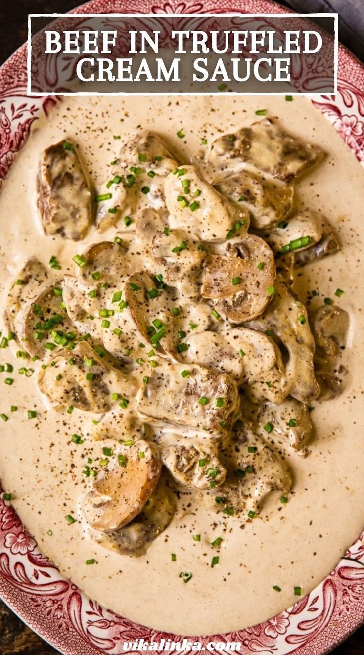 a red and white plate topped with mushrooms covered in gravy