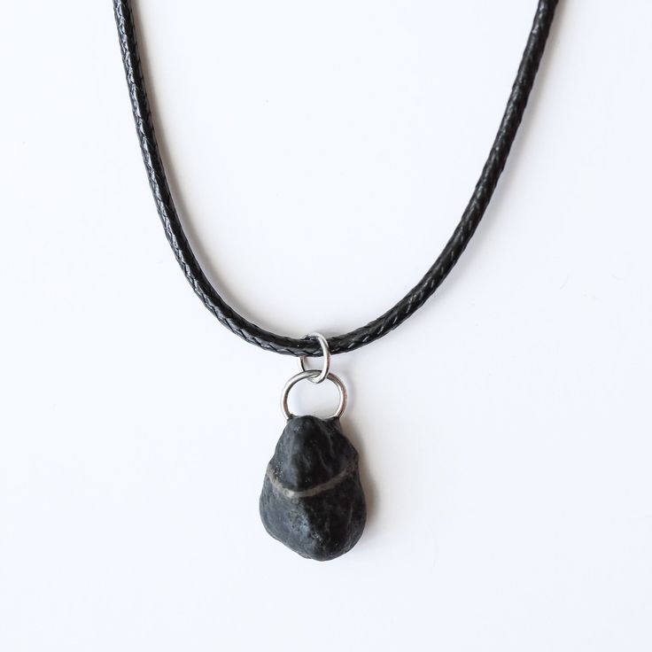 This necklace stone is sourced locally. A small black stone, with a fine white line through it brings attention to detail. It has depth with fine natural creases. stone is attached with uv resin to the back of a small hoop. Hanging on black cording. Made with alloy silver metal. Materials:Natural stoneAlloy silver chain and ring uv resin on back of stone to ring Rough Stone Necklace, Black Stone Pendant, Necklace Stone, White Line, Uv Resin, Black Stone, Stone Pendant, Stone Necklace, Stone Pendants