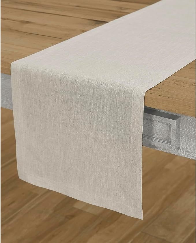 a white table runner on top of a wooden table