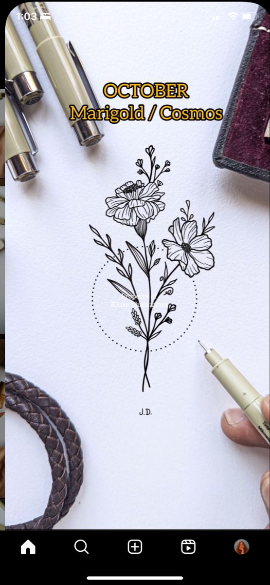 a person is drawing flowers on paper