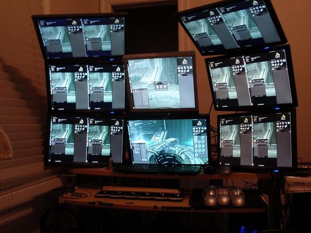 multiple monitors are displayed on top of a desk