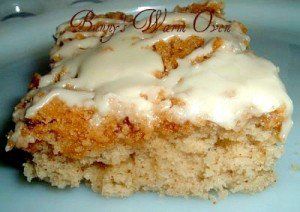 a close up of a piece of cake on a plate with icing and crumbs