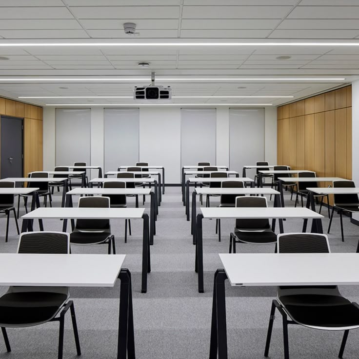 an empty classroom with desks and chairs