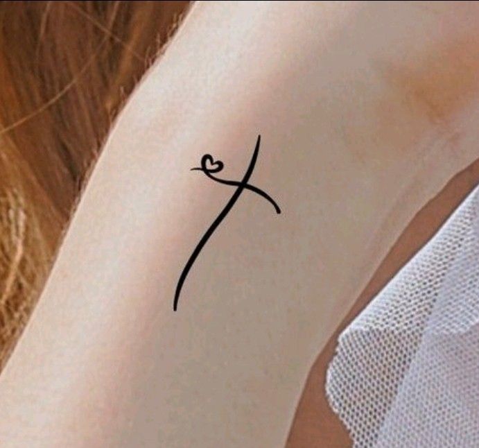 a woman's arm with a small tattoo on the back of her left arm