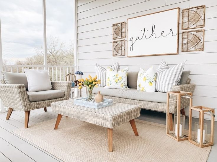 a living room filled with furniture on top of a hard wood floored porch area