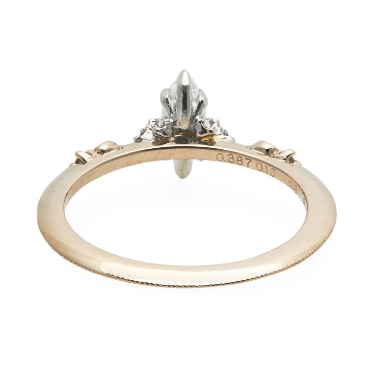 a yellow gold engagement ring with an oval shaped diamond on the top and side stones