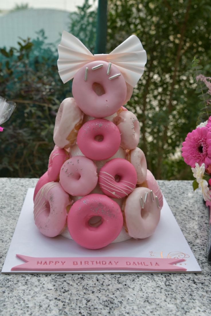 a birthday cake made to look like a doughnut tower