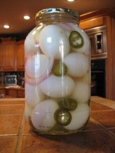 a jar filled with pickled eggs on top of a kitchen counter