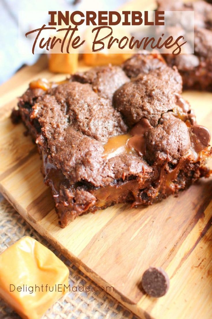 chocolate brownies with caramel drizzled on top are sitting on a cutting board