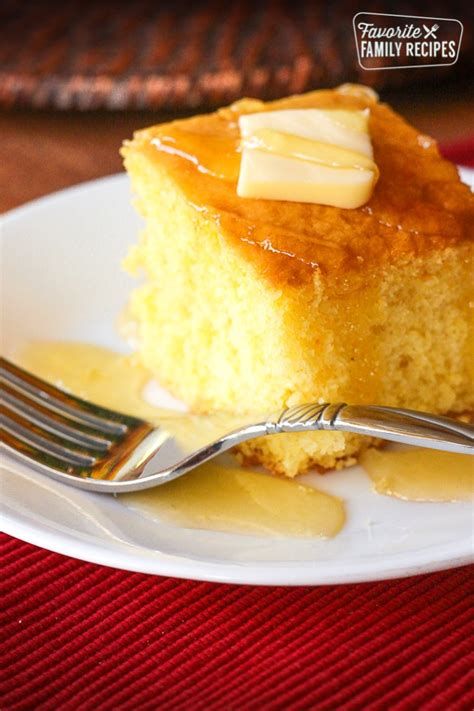 a piece of cornbread cake on a plate with a fork and caramel sauce