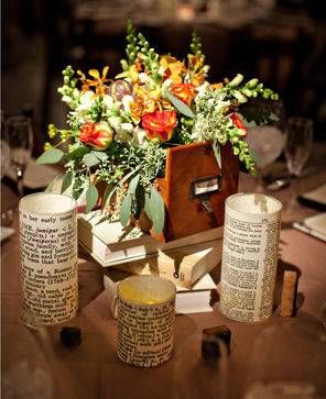 an arrangement of flowers and candles on a table