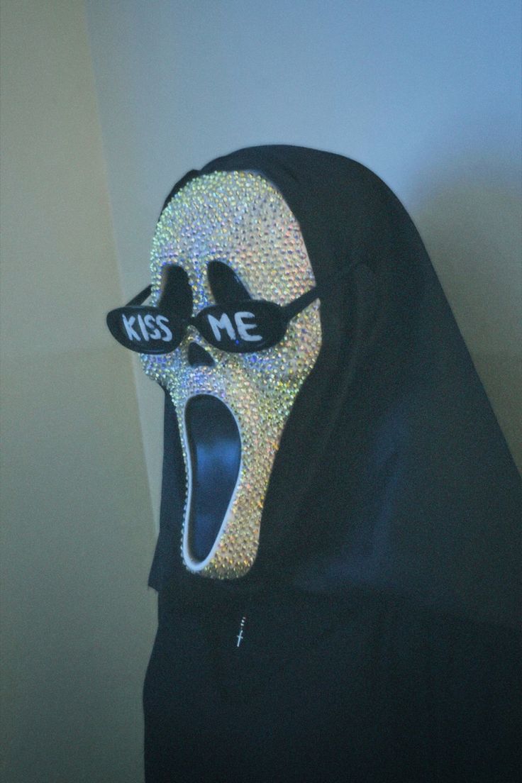 a person wearing a mask with the word kiss on it