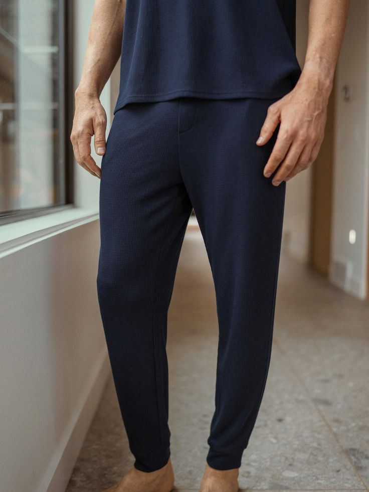 Experience a new level of comfort and style with our innovative Bamboo Waffle Knit Pant, featuring a relaxed fit with a pull-on elastic waistband and side pockets. Made from an eco-friendly blend of bamboo viscose, this pant is breathable, temperature-regulating, and odor-neutralizing, keeping you fresh and cool through hours of wear. Men's Bamboo Viscose Waffle Knit Pants in Navy (Size: Small) - Cozy Earth Pull-on Trousers For Loungewear, Relaxed Fit Tapered Leg Loungewear Pants, Relaxed Fit Tapered Leg Pants For Loungewear, Relaxed Fit Pull-on Sweatpants For Lounging, Straight Leg Pull-on Sweatpants For Loungewear, Elastic Cuffs Sweatpants For Loungewear, Straight Joggers With Elastic Waistband For Lounging, Elastic Cuff Sweatpants For Loungewear, Joggers With Ribbed Waistband For Loungewear