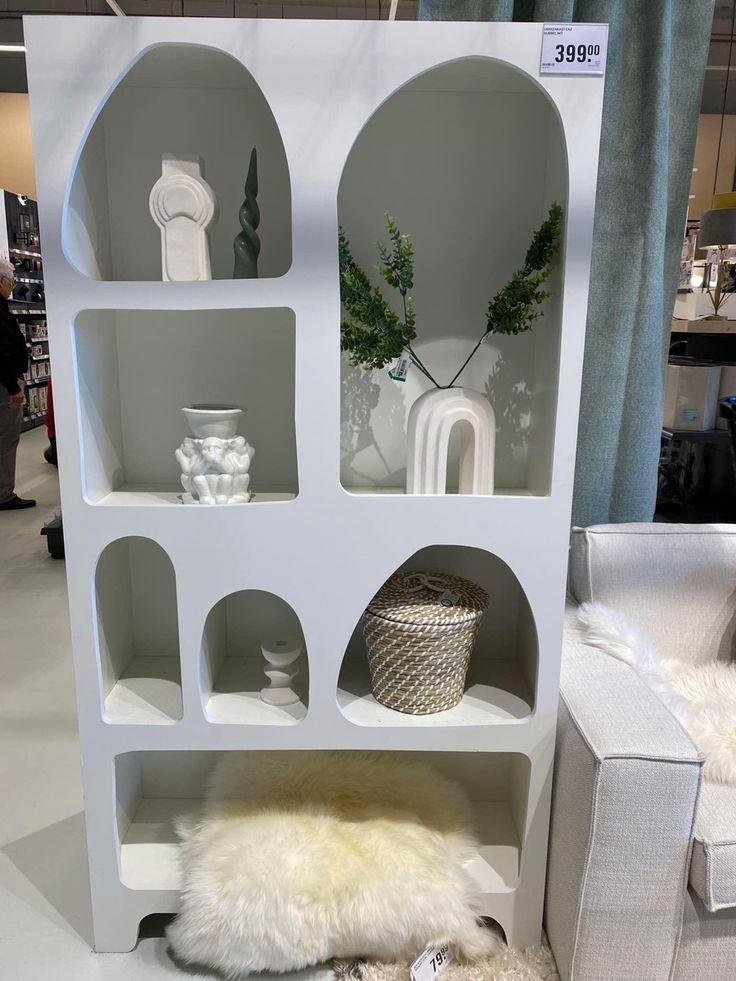 a white shelf filled with lots of furniture