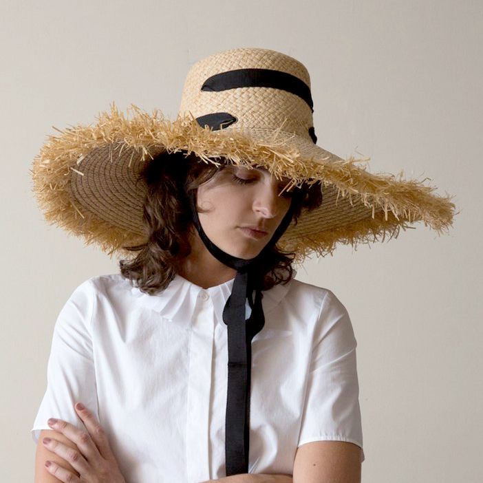 Made from an ultra-flexible woven raffia, the Alpargatas has a bucket crown that perches slightly higher on the head than most hats do. The brim is top-stitched and finished with a fringed edge that suggests endless sunny days spent beneath the shade of a palapa. A long grosgrain ribbon is threaded through eyelets to serve as a chin tie. Knot it saucily beneath your left ear, or just let the hat hang nonchalantly down your back as you stroll from beach, to market, to festival. Lola Hats combine Pale White Skin, Woven Raffia, Ribbon Design, Black Ribbon, Your Back, Grosgrain Ribbon, Summer Style, Panama Hat, Fedora