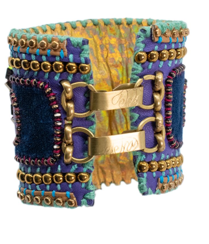 Introducing the **De Petra Signature Cuff Bracelet**, a masterpiece of artisanal craftsmanship that epitomizes elegance and individuality. Each bracelet is a labor of love, meticulously handcrafted over a span of three to four days by the artist herself, ensuring that no two pieces are ever alike. The creation process begins with the selection of the finest Italian leather, known for its unparalleled quality and luxurious texture. The leather forms the foundation of the cuff, carefully cut and shaped to embrace the wrist with comfort and style. The rich, earthy tones of the leather exude sophistication, setting the stage for the layers of artistry to come. Next, a layer of sumptuous silk velvet is hand-stitched onto the leather. This velvet, with its soft, plush feel, adds a touch of opule Handmade Cuff Bracelet For Formal Occasions, Unique Handmade Bracelets, Luxury Handmade Cuff Bracelet For Formal Occasions, Luxury Adjustable Jubilee Cuff Bracelet, Bohemian Cuff Bracelets For Formal Occasions, Bohemian Cuff Bracelet For Formal Occasions, Luxury Adjustable Bangle Cuff Bracelet, Handmade Cuff Bracelets For Formal Occasions, Luxury Handmade Ceremonial Bracelets