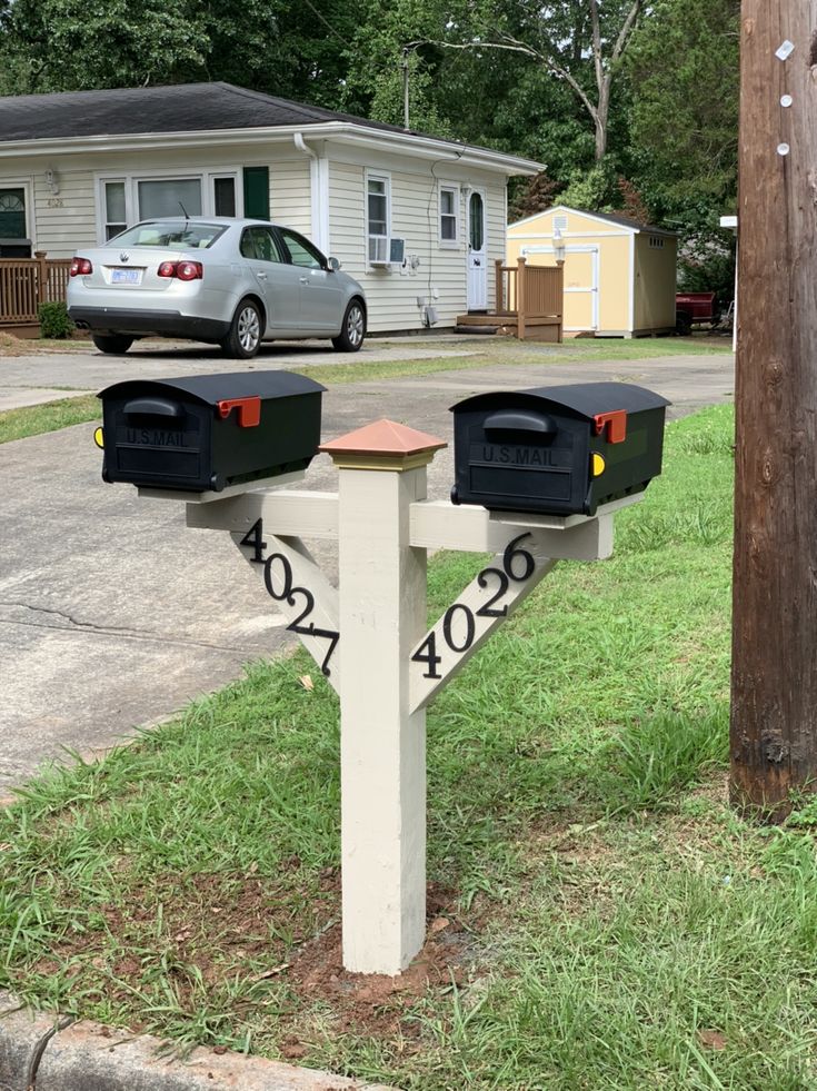 two mailboxes are in front of a house