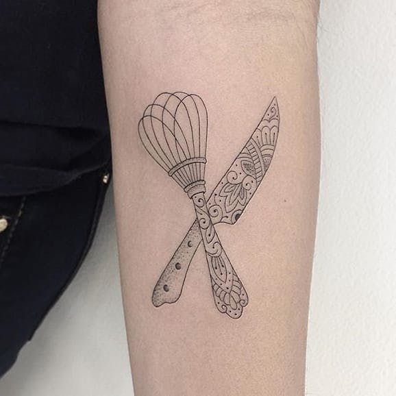 two kitchen utensils tattoo on the right forearm and left arm with an intricate design