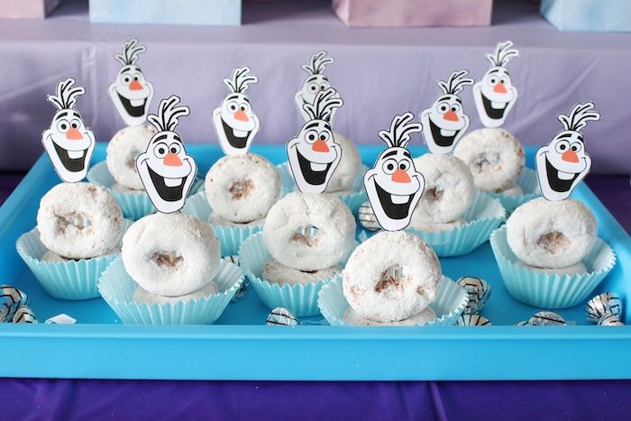 a tray filled with frosted donuts topped with cartoon characters on top of them