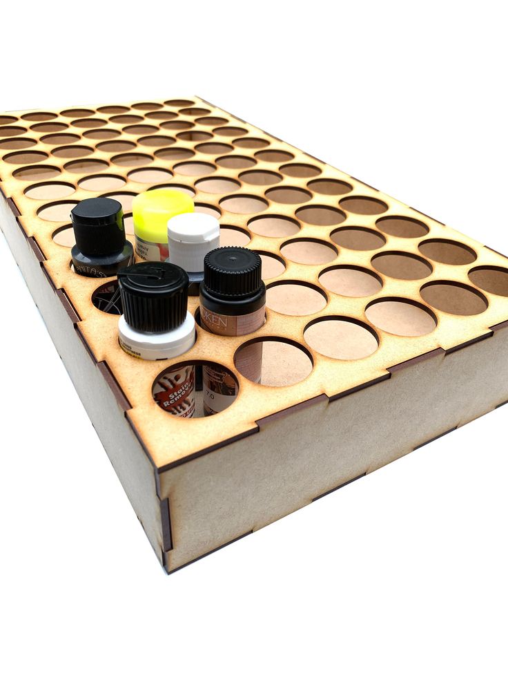 a wooden board game with several different types of paints and condiments on it