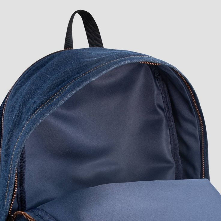 This Levi's backpack is signature style designed with everyday function in mind. It's made of durable denim containing sustainably sourced cotton and lined with lightweight poly to reinforce the integrity of the bag. The zippered main compartment is spacious enough to hold what you need for the day and the zippered back compartment is padded, and can be used to hold your laptop or tablet. Use the bottle pocket on the side to hold your beverage and the zippered pocket on the front to help secure Casual Canvas Backpack With Zipper Pocket, Casual Denim Blue Standard Backpack, Denim Blue Standard Backpack With Zipper, Denim Blue Backpack With Zipper For Daily Use, Denim Blue Backpack For Travel, Denim Blue Travel Backpack With Zipper Closure, Denim Blue Travel Backpack With Zipper, Denim Blue Backpack For Everyday And Back To School, Denim Blue Backpack With Zipper Closure