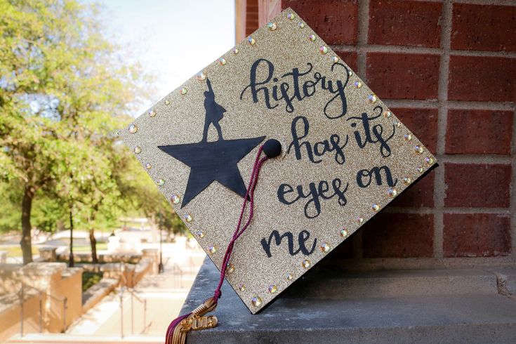 a graduation cap that says, history has its eyes on me