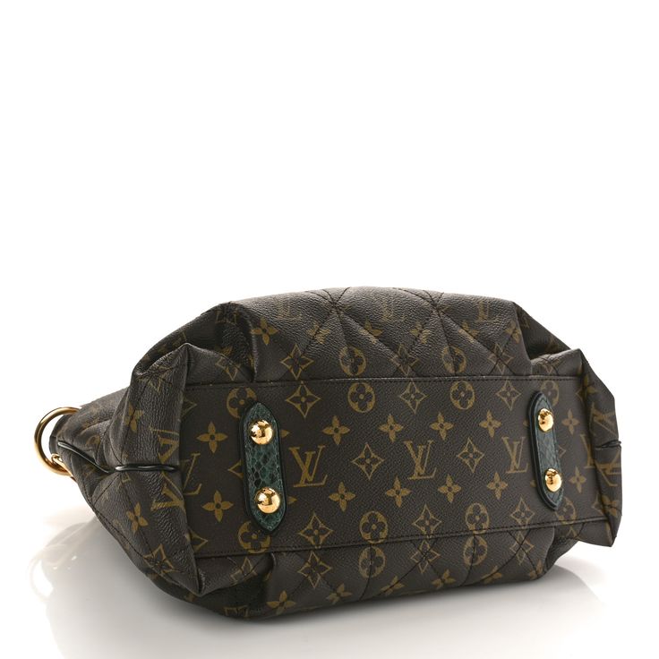 This is an authentic LOUIS VUITTON Monogram Etoile Exotique MM Blue. This unique handbag is crafted of medium padded, quilted Louis Vuitton monogram coated canvas in brown. The bag features green snakeskin top handles, a matching adjustable shoulder strap, and a tiger-eye twist lock and pocket on the front. The top is open to a light brown ostrich top crest and a brown microfiber interior with zipper and patch pockets. Unique Handbag, Authentic Louis Vuitton, Tiger Eye, Snake Skin, Louis Vuitton Monogram, Patch Pocket, Light Brown, Shoulder Strap, Handles