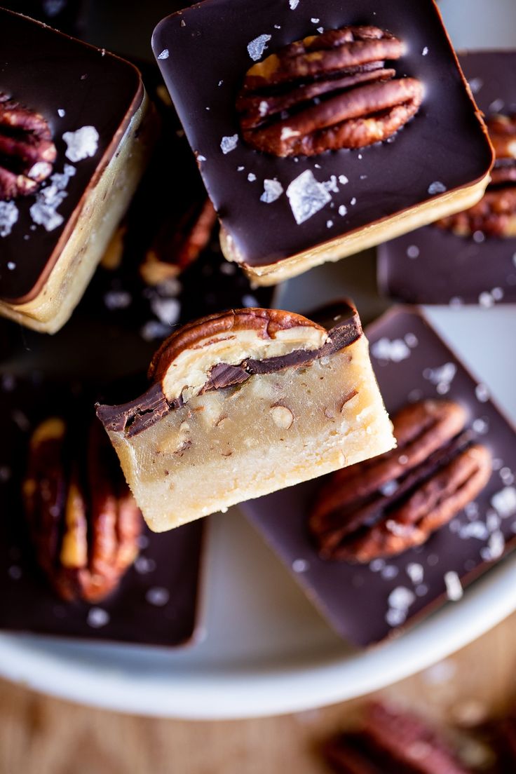 several pieces of chocolate and pecans on a plate