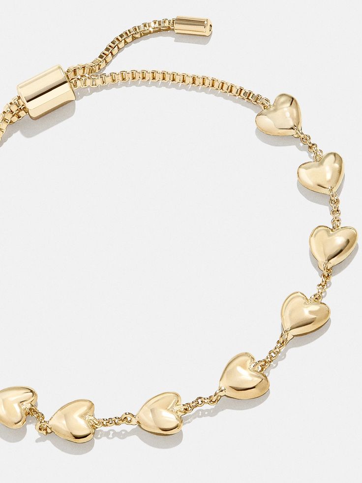 The Brittany Bracelet is the perfect way to add a subtle dose of affection to your curated wrist stack. This bracelet features petite heart adornments with chic negative space in between. Better yet, it's finished off with a pull-tie closure, meaning you'll always get the perfect fit. Gold Bracelet Amazon, Gold Heart Bracelet For Women, Gold Stacking Bracelets, Cute Gold Jewelry, Gold Jewelry Bracelets, Gold Bracelet Stack, Wrist Stack, Gold Bracelets Stacked, Bauble Bar