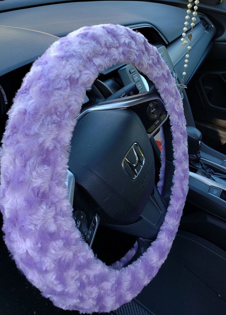 the steering wheel cover is covered in fuzzy purple material