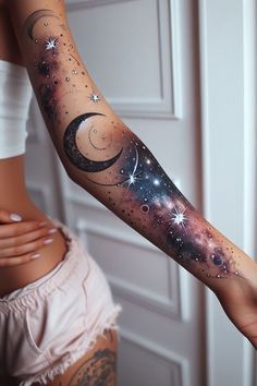 a woman's arm with stars and planets on it